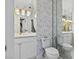 Charming bathroom with floral wallpaper, mirrored walls, and elegant lighting fixtures at 21 Sawgrass Ct, Las Vegas, NV 89113