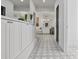 Elegant bathroom featuring white cabinetry, patterned tile floors, and a walk-in shower for a spa-like experience at 21 Sawgrass Ct, Las Vegas, NV 89113