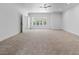Spacious bedroom features neutral carpet, natural light, and access to a patio at 21 Sawgrass Ct, Las Vegas, NV 89113