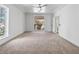 Bedroom with neutral carpet, a ceiling fan, and a view of the balcony at 21 Sawgrass Ct, Las Vegas, NV 89113