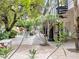 Beautiful courtyard with a pool, lush greenery, spiral staircase access to the upper level, and serene landscaping at 21 Sawgrass Ct, Las Vegas, NV 89113