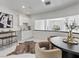 Stylish dining area with a modern wet bar, round table, seating, and contemporary décor at 21 Sawgrass Ct, Las Vegas, NV 89113