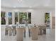 Dining room featuring a glass-top table, modern chairs, and a view of the lush outdoor scenery at 21 Sawgrass Ct, Las Vegas, NV 89113