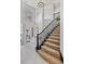 Bright entryway features a staircase with carpeted steps and black banister at 21 Sawgrass Ct, Las Vegas, NV 89113