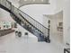 Elegant entryway with a grand staircase, marble floors, and neutral palette at 21 Sawgrass Ct, Las Vegas, NV 89113