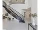 Bright entryway features a curved staircase, marble floors, and modern decor at 21 Sawgrass Ct, Las Vegas, NV 89113