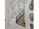 Bright foyer features a staircase with carpeted steps and black banister at 21 Sawgrass Ct, Las Vegas, NV 89113