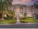 Stunning home featuring a well-manicured lawn, beautiful landscaping, and a decorative driveway at sunset at 21 Sawgrass Ct, Las Vegas, NV 89113
