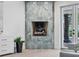 Elegant fireplace clad in unique stone, complemented by a glimpse of the outdoor pool area at 21 Sawgrass Ct, Las Vegas, NV 89113