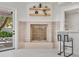 Cozy fireplace with light tile surround and bar seating at 21 Sawgrass Ct, Las Vegas, NV 89113