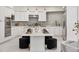 Modern kitchen with white cabinets, stainless steel appliances, a beautiful island, and plenty of counter space at 21 Sawgrass Ct, Las Vegas, NV 89113