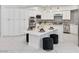Kitchen featuring white cabinets, marble countertops, stainless steel appliances, and a stylish island for entertaining at 21 Sawgrass Ct, Las Vegas, NV 89113