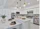 Bright, modern kitchen with white cabinets, marble countertops, stainless steel appliances, and stylish pendant lighting at 21 Sawgrass Ct, Las Vegas, NV 89113