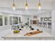 Bright kitchen with a large island, modern lighting fixtures, and open layout to the dining and living areas at 21 Sawgrass Ct, Las Vegas, NV 89113