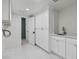 Functional laundry room with ample storage, sink, and access to the stylish shower at 21 Sawgrass Ct, Las Vegas, NV 89113