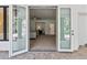 View from patio doors, leading into a carpeted living room bathed in natural light at 21 Sawgrass Ct, Las Vegas, NV 89113