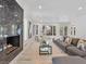 Sunlit living room with views, a fireplace, and an open concept layout at 21 Sawgrass Ct, Las Vegas, NV 89113