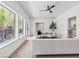 Bright living room with white seating, ceiling fan, and access to a patio at 21 Sawgrass Ct, Las Vegas, NV 89113