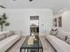 Neutral living room featuring a modern glass coffee table, comfortable seating, and stylish decor at 21 Sawgrass Ct, Las Vegas, NV 89113