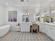 Bright main bathroom featuring a soaking tub, vanity and stylish tile flooring at 21 Sawgrass Ct, Las Vegas, NV 89113