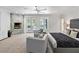 Spacious main bedroom features a stone fireplace, cozy seating, and doors leading to a private outdoor area at 21 Sawgrass Ct, Las Vegas, NV 89113