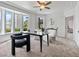 Home office with carpet flooring, natural light, modern furniture, and stylish black and white chairs at 21 Sawgrass Ct, Las Vegas, NV 89113