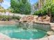 Beautiful custom pool features a rock waterfall, creating a tranquil backyard retreat at 21 Sawgrass Ct, Las Vegas, NV 89113