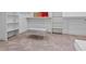 Spacious walk-in closet with built-in shelving, carpeted floors, and a comfortable gray bench, offering ample storage at 21 Sawgrass Ct, Las Vegas, NV 89113