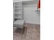 Well-organized walk-in closet with built-in shelves, carpeted floors, and a stylish gray bench at 21 Sawgrass Ct, Las Vegas, NV 89113