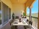Inviting outdoor dining space on a covered balcony with elegant furnishings and scenic views at 21 Via Visione # 206, Henderson, NV 89011