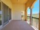 Covered balcony featuring decorative columns, rod iron railing and serene, unobstructed views at 21 Via Visione # 206, Henderson, NV 89011