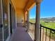 Expansive covered balcony with ornate columns and rod iron railings offering scenic views at 21 Via Visione # 206, Henderson, NV 89011