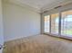 Bedroom features private outdoor patio access, neutral carpet, and baseboard trim at 21 Via Visione # 206, Henderson, NV 89011