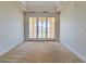 Bright bedroom featuring plush carpeting and balcony access through sliding glass doors at 21 Via Visione # 206, Henderson, NV 89011