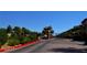 Gated community entrance with lush landscaping, trees, and clear signage for a welcoming first impression at 21 Via Visione # 206, Henderson, NV 89011