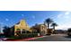 Community clubhouse with lush landscaping, palm trees, and elegant architectural details at 21 Via Visione # 206, Henderson, NV 89011