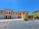Mediterranean-style townhome community showcasing stucco exterior, garages, and landscaping at 21 Via Visione # 206, Henderson, NV 89011