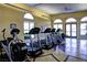 Community gym featuring treadmills, elliptical machines, and ample natural light from the surrounding windows at 21 Via Visione # 206, Henderson, NV 89011