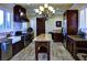 Well-lit kitchen featuring dark wood cabinetry, stainless steel appliances, stone tile floors, and a butcher block island at 21 Via Visione # 206, Henderson, NV 89011