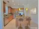 Well-equipped kitchen with stainless steel appliances, island with seating, and wooden cabinets at 21 Via Visione # 206, Henderson, NV 89011