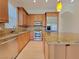 Bright kitchen with stainless appliances, granite counters, breakfast bar, and light wood flooring at 21 Via Visione # 206, Henderson, NV 89011