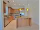Kitchen featuring an island with bar stool seating and stainless steel appliances at 21 Via Visione # 206, Henderson, NV 89011