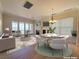 Open-concept living and dining space with fireplace and access to balcony at 21 Via Visione # 206, Henderson, NV 89011
