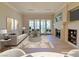Elegant living room showcasing fireplace, balcony access, and stylish furnishings at 21 Via Visione # 206, Henderson, NV 89011