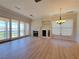 Spacious living room with hardwood floors, fireplace and sliding glass doors to the balcony with a view at 21 Via Visione # 206, Henderson, NV 89011