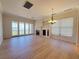 Bright living room with fireplace, hardwood floors and sliding glass doors to the balcony with views at 21 Via Visione # 206, Henderson, NV 89011