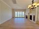 Large living room with fireplace, built-in shelving, and access to the balcony at 21 Via Visione # 206, Henderson, NV 89011