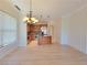 Open-concept living space with hardwood floors, kitchen island, and ample natural light at 21 Via Visione # 206, Henderson, NV 89011