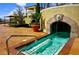 Unique pool featuring a waterfall grotto and seating, enhanced by mature landscaping at 21 Via Visione # 206, Henderson, NV 89011