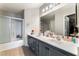 Bright bathroom with dual sinks and a glass-enclosed shower at 2307 Tuscarora Ct, Las Vegas, NV 89142